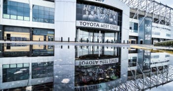 Pride Park Stadium reflected in a puddle.