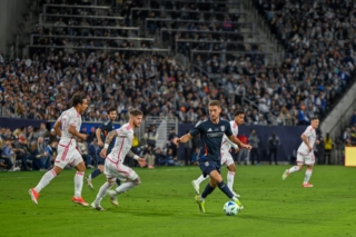 Defender Chris McVey dribbles the ball away from St. Louis City SC players during their ingural match at Snapdragon Stadium on Sat. March 1, 2025.