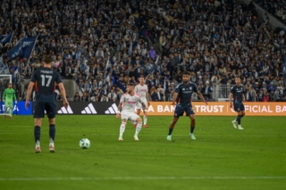 Midfielder Anibal Godoy signals to Defender Paddy McNair.
